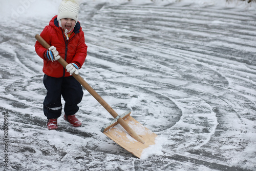 Children play outside in the winter. Snow games on street.