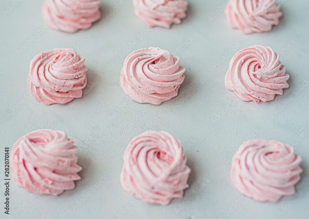 Meringue zephyr marshmallows on a light background. Pink sweet homemade marshmallow. meringue on white background. Meringue zephyr marshmallows on a light background. Pink sweet homemade marshmallow. meringue on white background.