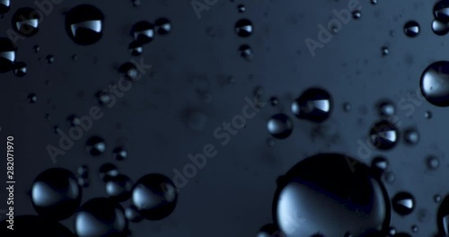 Color drops floating in oil and water over a colorful background