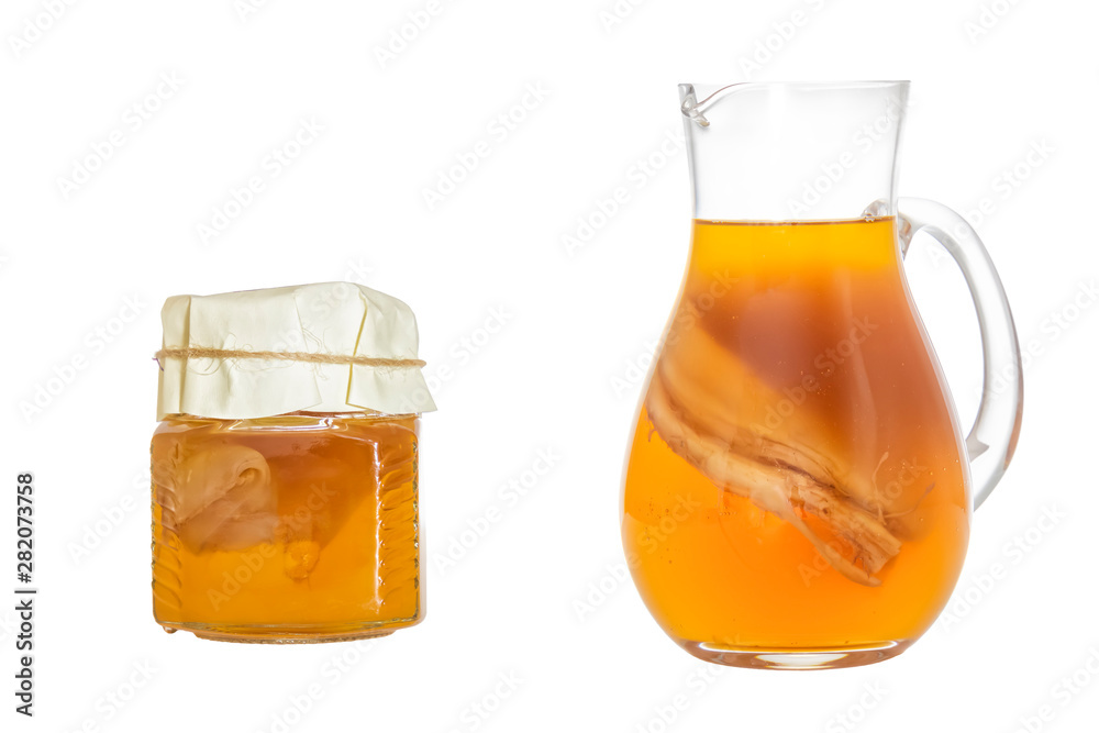 Homemade fermented drink Kombucha in a glass jug and jar. Isolated on white background Homemade fermented drink Kombucha in a glass jug and jar. Isolated on white background