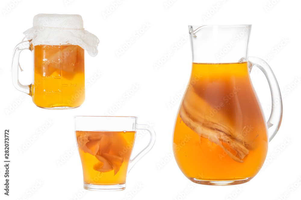 Homemade fermented drink Kombucha in a glass jug and jar. Isolated on white background Homemade fermented drink Kombucha in a glass jug and jar. Isolated on white background