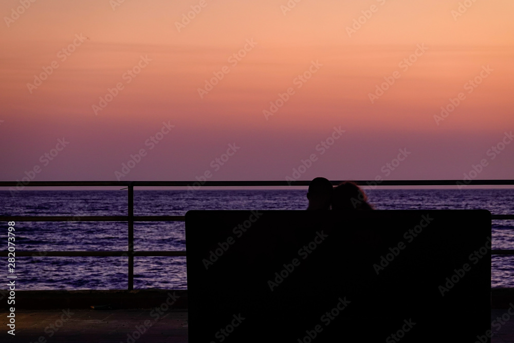 Syracuse, Ortegia, Sicily, Italy A couple watch the sunrise.