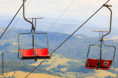 Empty mountain ski lift chair at summer time.