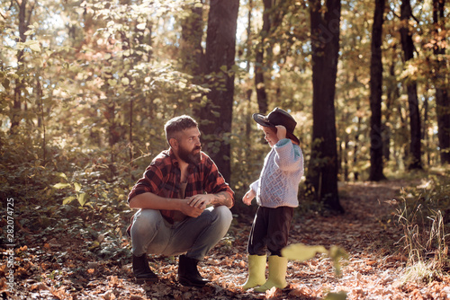 My dad cowboy. Hipster bearded dad with cute son spend time together in forest. Family time. Family leisure. Explore nature. Wanderlust concept. Brutal bearded man and little boy family enjoy nature