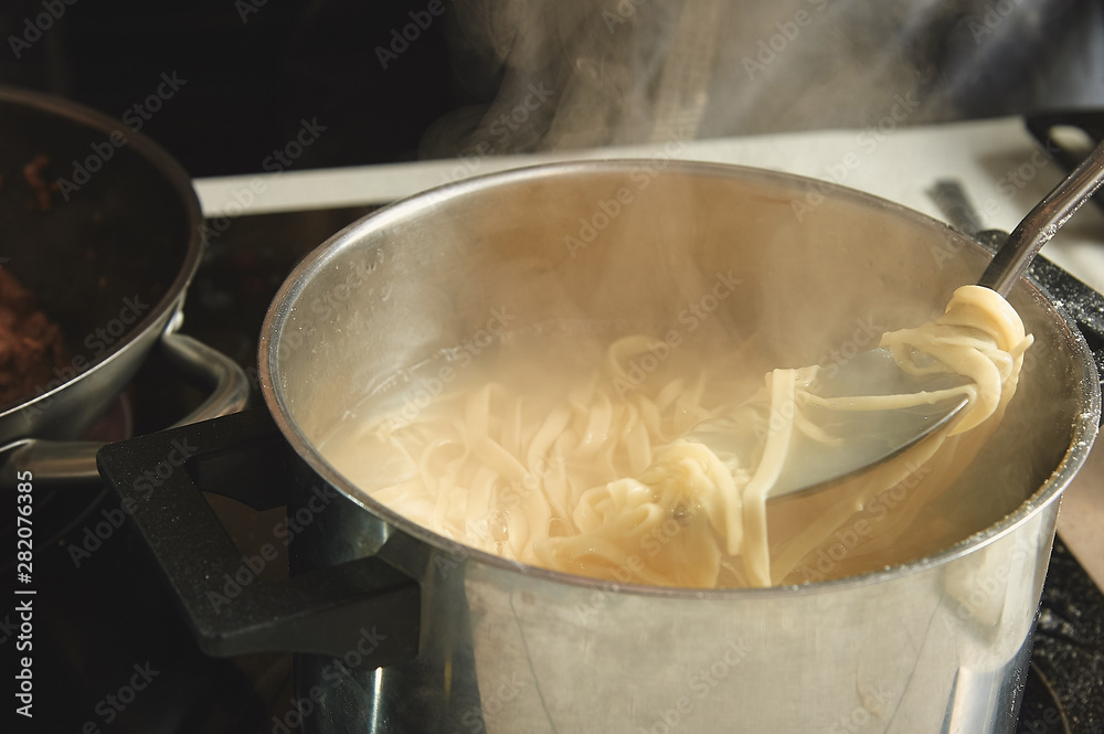 raw wok noodles cook in a pan