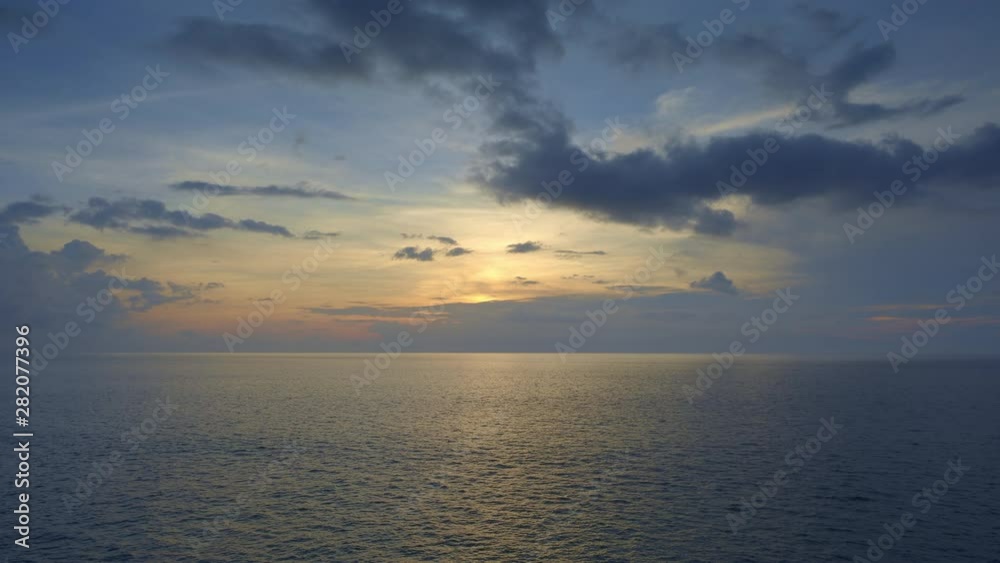 Beautiful dramatic sunset with dark blue and yellow sky in indian ocean Beautiful dramatic sunset with dark blue and yellow sky in indian ocean