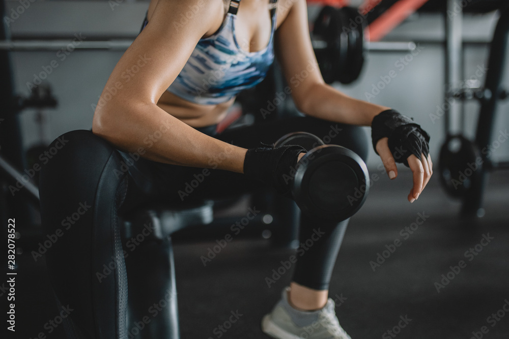 Shot of asian women lifting dumbbells at the gym, Concept of exercise girl Shot of asian women lifting dumbbells at the gym, Concept of exercise girl