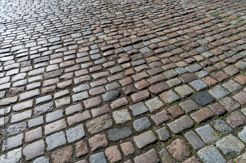 Old paving stones pattern. Texture of ancient german cobblestone in city downtown. Little granite tiles. Antique gray pavements. photo