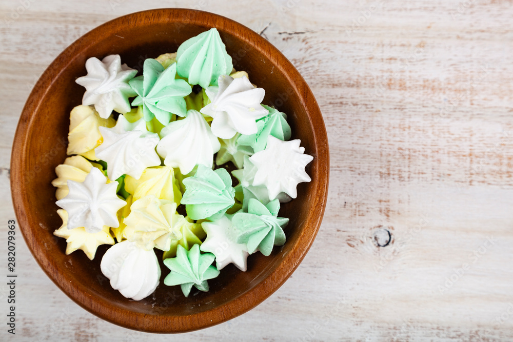 Meringue in a bowl on a wooden background Meringue in a bowl on a wooden background
