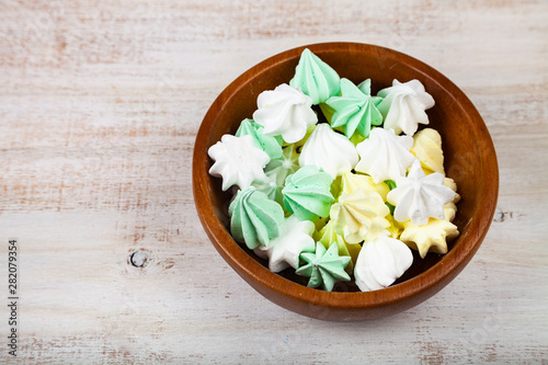 Meringue in a bowl on a wooden background