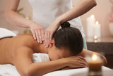 Portrait of beautiful woman enjoying massage in luxury spa by candlelight, copy space