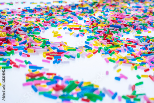 Colorful candy sprinkles close up for birthday cake on white background