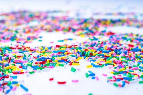 Colorful candy sprinkles close up for birthday cake on white background