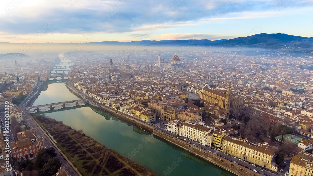 AERIAL. Panorama of the city of FLORENCE in Italy with the dome and Palazzo della Signoria and arno river