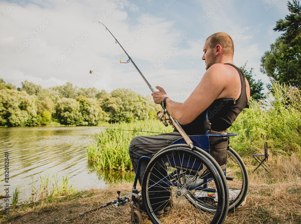 Handicapped man fishing at a lake. Wheelchair. Camping. Stock Photo | Adobe  Stock