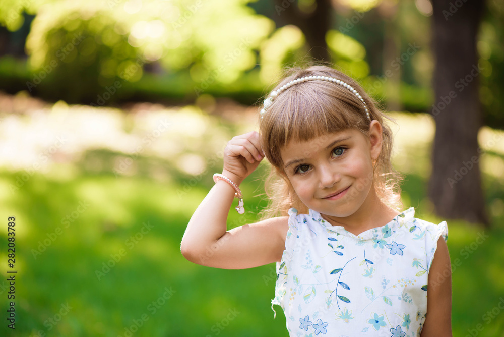 Beautiful little young girl outdoorin a park. Beautiful little young girl outdoorin a park.