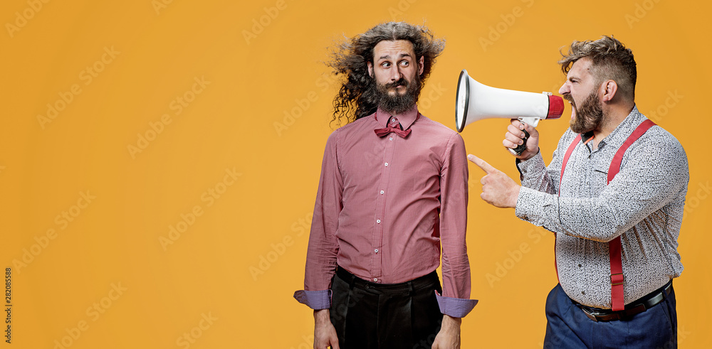 Upset boss yelling at his employee with a megaphone - obrazy, fototapety, plakaty 
