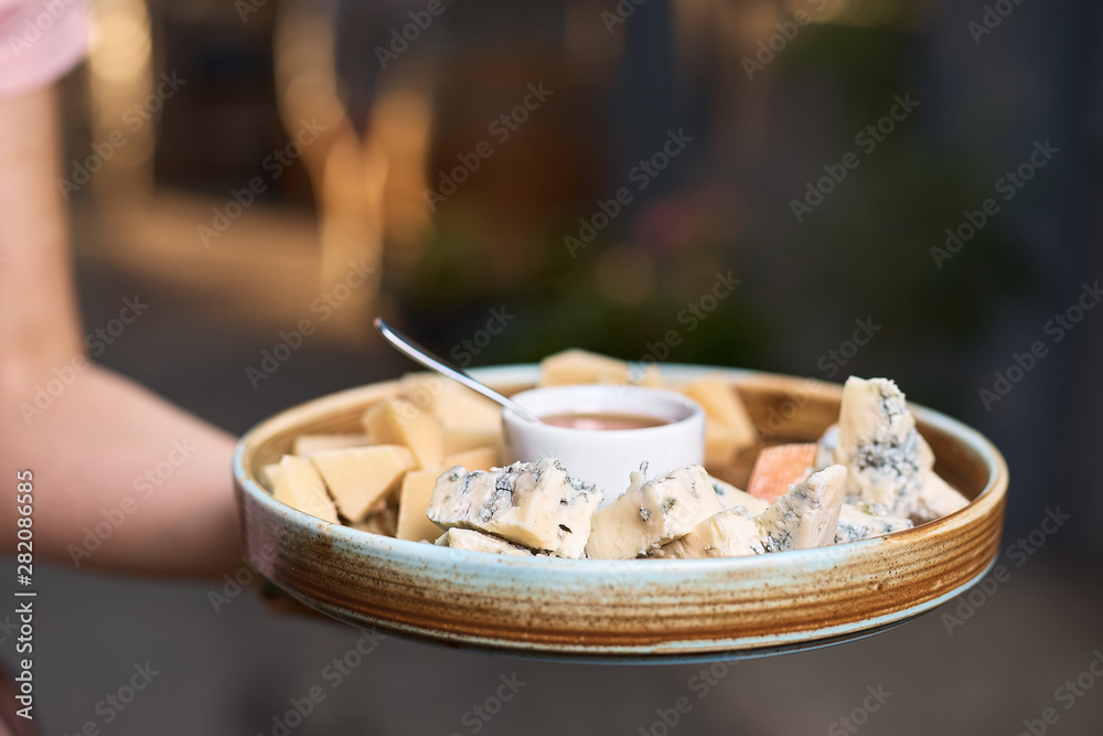 cheese plate in the hands of the chef