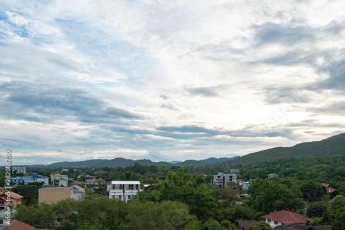 landscape aerial view of building in city nearby the mountain at Chiang Mai Thailand with beautiful sky
