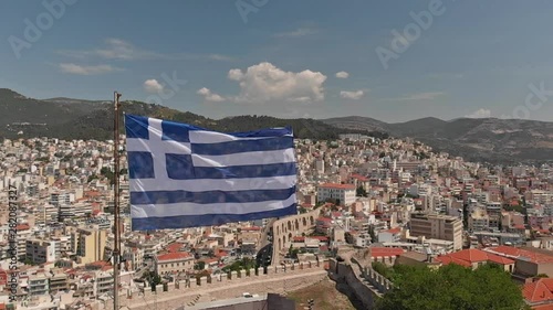 Greek flag waving in slow motion in Kavala city