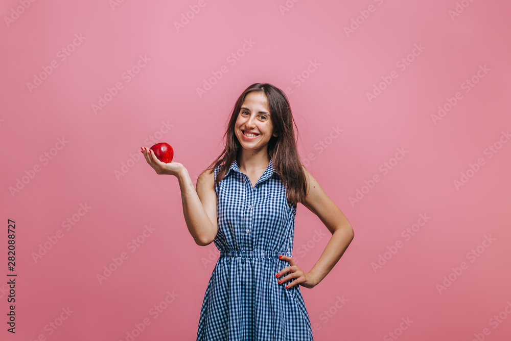 Girl holding red Apple on pink background Girl holding red Apple on pink background
