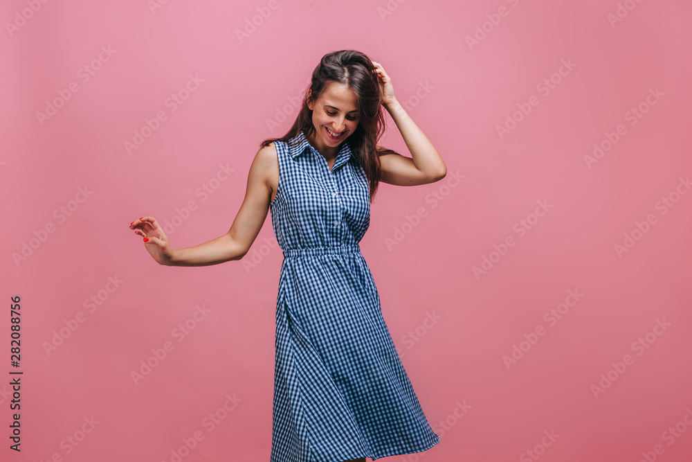 Girl in blue dress dancing on pink background Girl in blue dress dancing on pink background