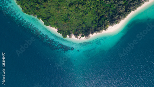 Aerial view of tropical Island white sand beach alonf the pine tree anf turqouise water at Koh Kradan Island, Trang, Thailand. Beach top view. 