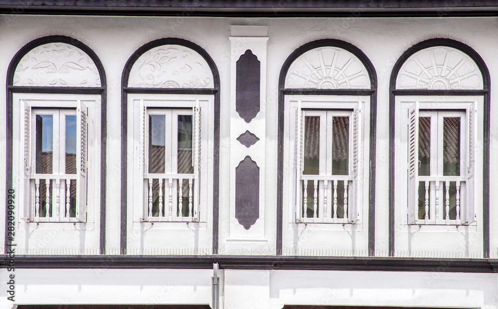 Retro windows on white wall , old town front outdoor view