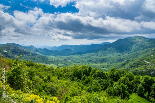 Montenegro, Endless wide green nature landscape view over skadar valley scenery of mountains and hills covered by trees and forest near skadar lake photo