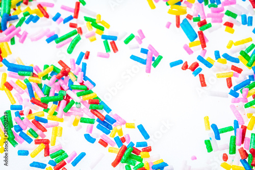 Colorful candy sprinkles close up for birthday cake on white background