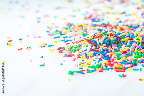 Colorful candy sprinkles close up for birthday cake on white background