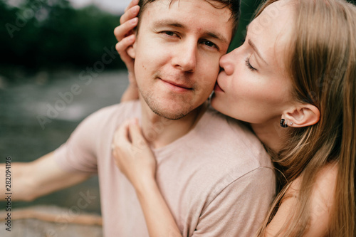 Lifestyle loving couple hugging at nature