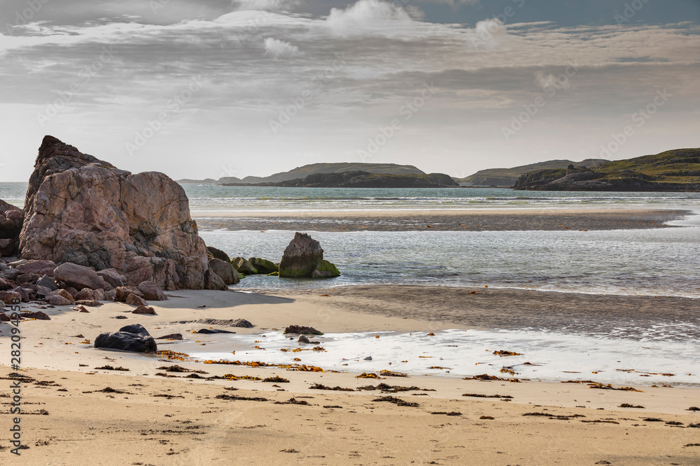 Fototapeta premium sandy beach with dune grass in Scotland, Isle of Lewis at low tide