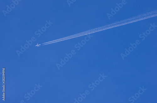 airplane and its contrail in the sky
