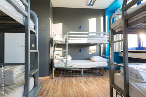 Hostel interior, metal bunk beds and linen, nobody photo