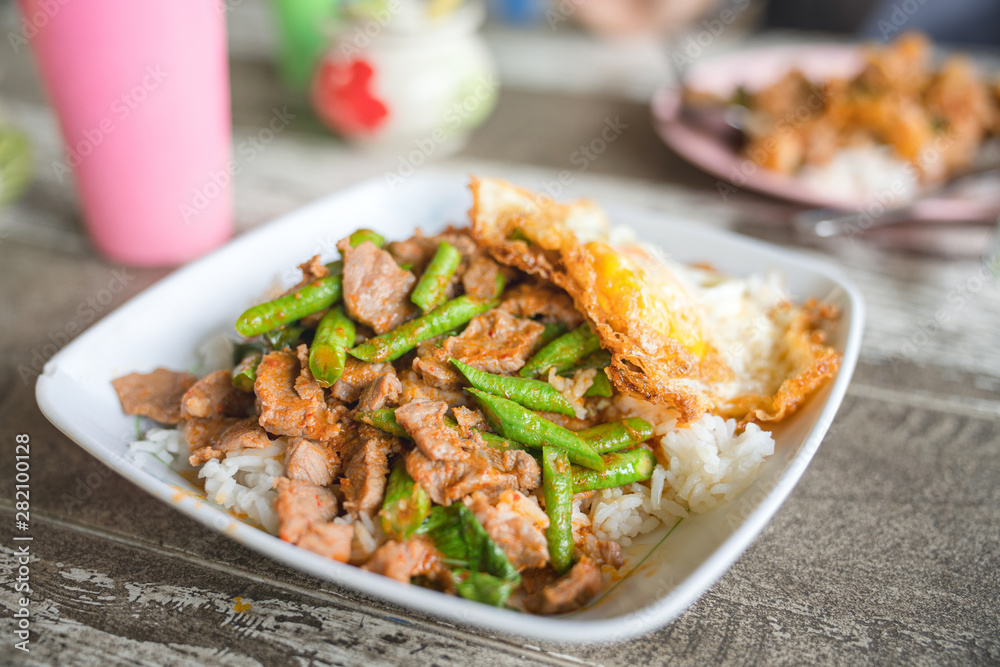 Asian style stir-fried string beans with beef,Beef stir fry over white rice and vegetables Asian style stir-fried string beans with beef,Beef stir fry over white rice and vegetables
