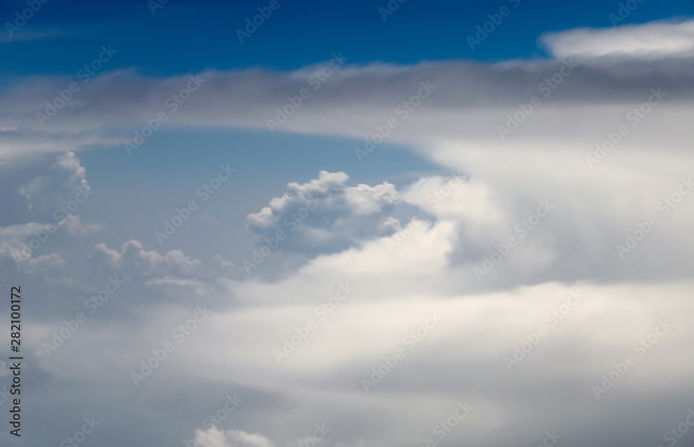 Blue sky and silky white clouds with impressive shapes, views over the heights