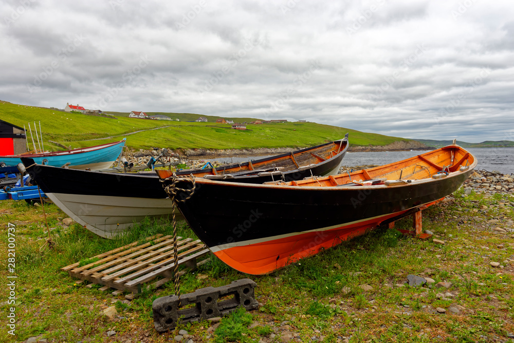 Old wooden boats stored on shore at Sandwick on the Main Shetland Isle, which is located northeast of the Scottish mainland