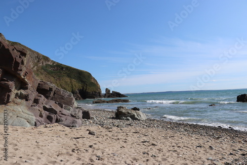 sandy beach in pembrokeshire with blue sky 