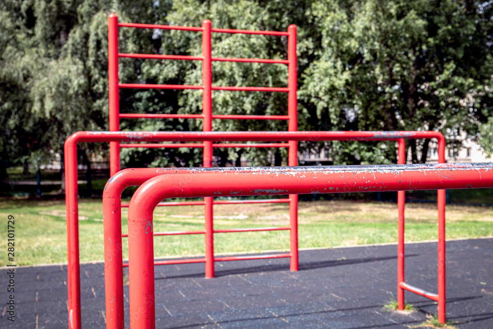 Red gymnastic bars outdoors, open-air gym Red gymnastic bars outdoors, open-air gym