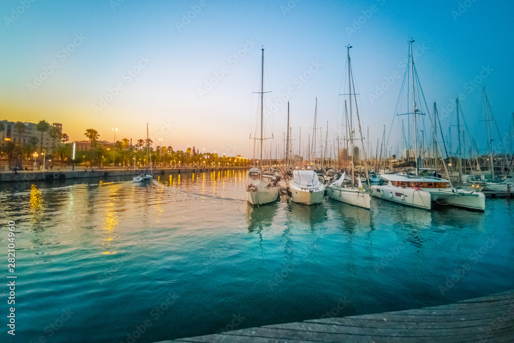 Admiral sailing port near Maremar mall on the coast of Barcelona at dusk to down in Spain Admiral sailing port near Maremar mall on the coast of Barcelona at dusk to down in Spain
