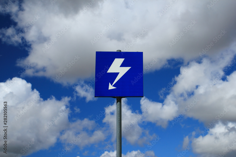 Sign with lightning over blue sky with beatiful clouds Sign with lightning over blue sky with beatiful clouds