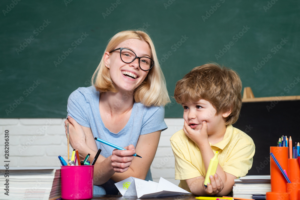 Elementary school - education and learning child concept. Child from elementary school with book. Teacher and child. Great study achievement Elementary school - education and learning child concept. Child from elementary school with book. Teacher and child. Great study achievement