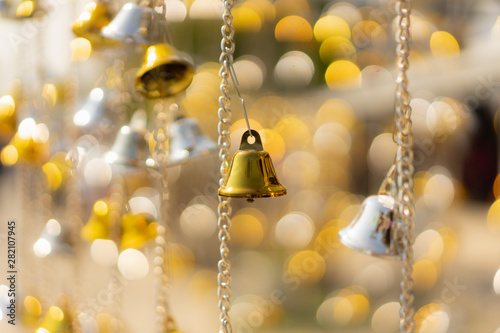 Christmas bells on the tree against defocused background, Congratulations on Christmas and New Year concepts.