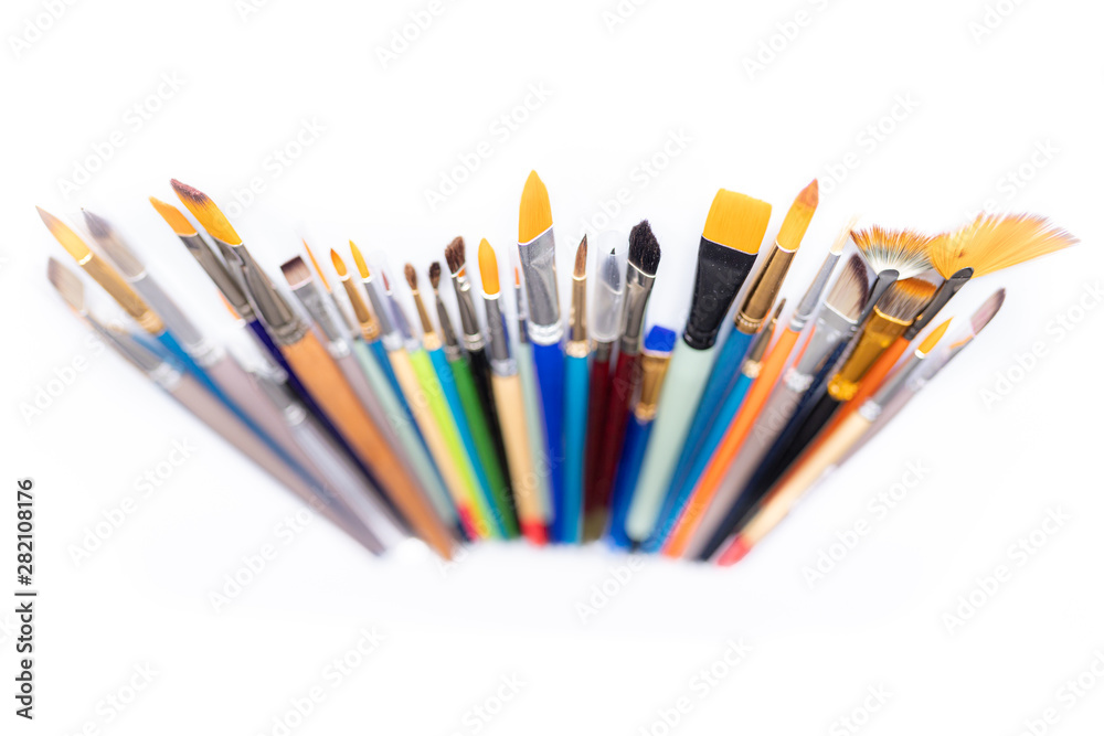 Fototapeta premium Colorful cosmetic brushes close up on white background