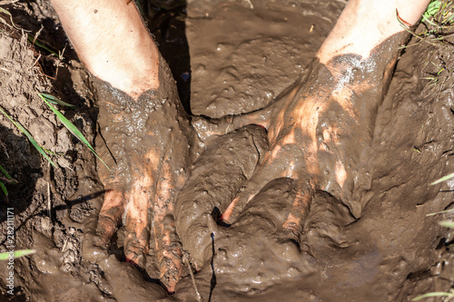 Boy working and playing in the mud