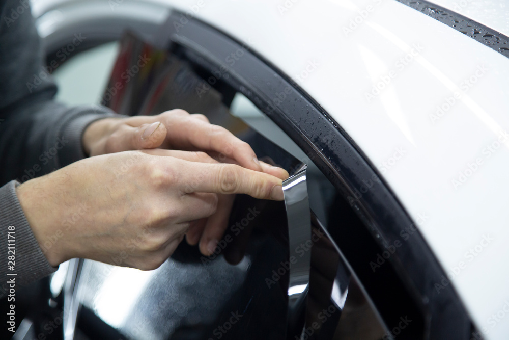 Install windows film on the car. Tinted Windows of the car.