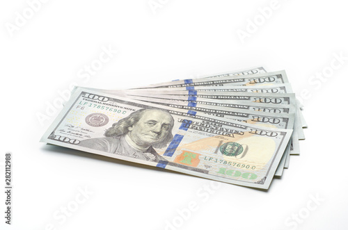 Seven hundred dollars in hundred dollar bills lie on a white background.
