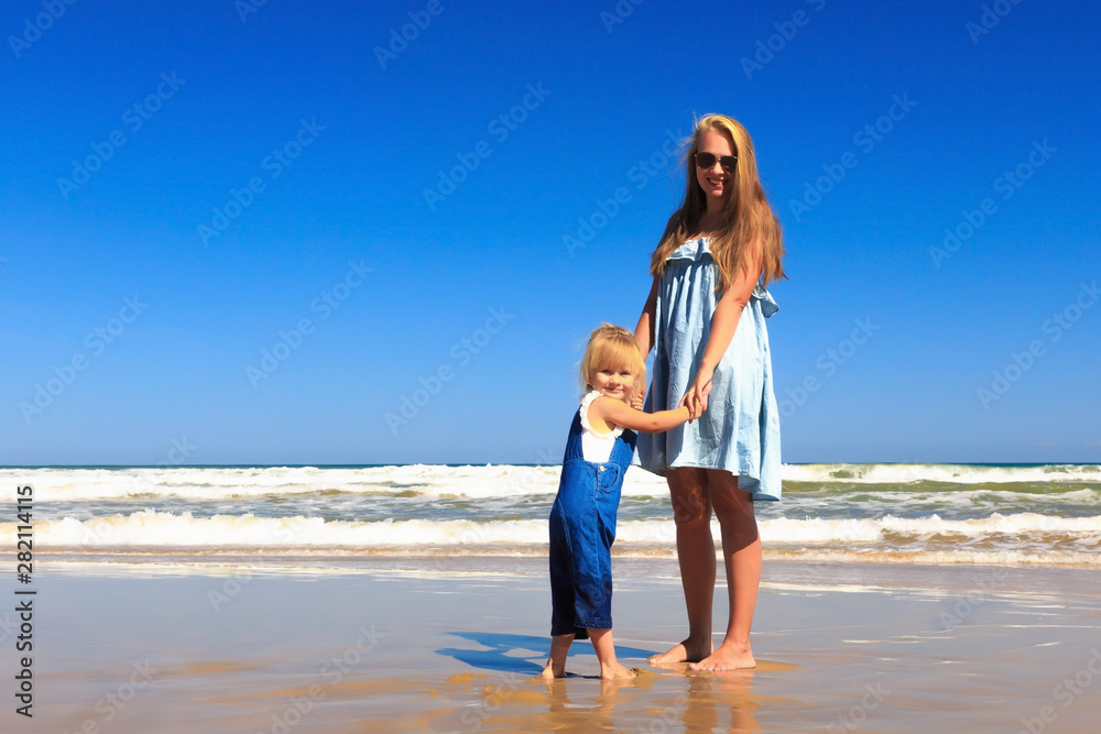 Happy Family! Mother and daughter stand on the beach. Happy Family! Mother and daughter stand on the beach.