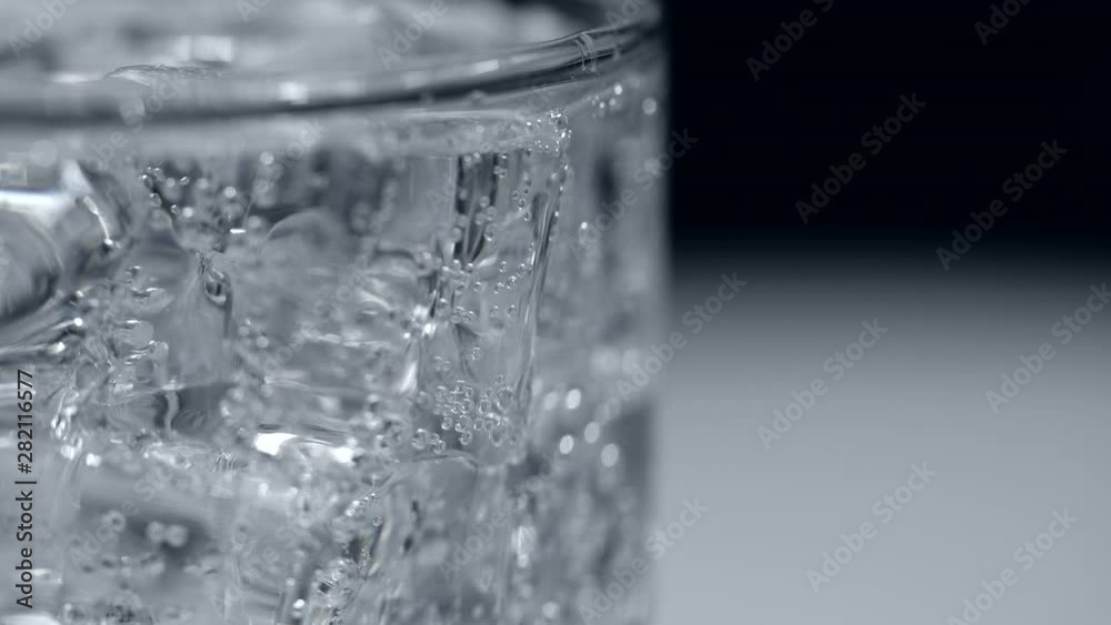 Close-up ice and soda water with bubbles background Close-up ice and soda water with bubbles background